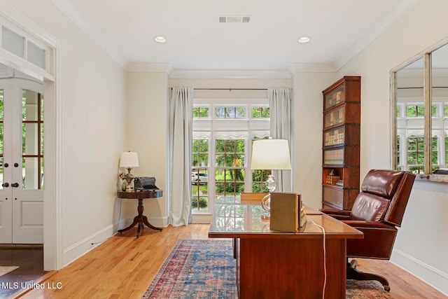 office area featuring crown molding, light wood-type flooring, and french doors