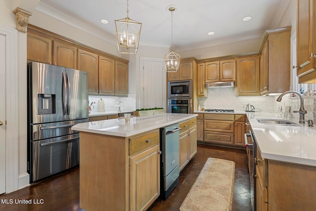 kitchen with sink, a center island, pendant lighting, appliances with stainless steel finishes, and tasteful backsplash