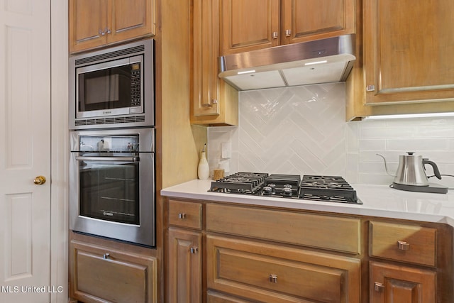 kitchen featuring backsplash and stainless steel appliances