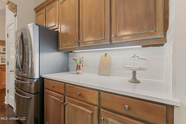 kitchen featuring decorative backsplash and stainless steel fridge