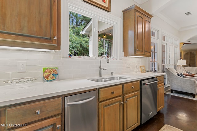 kitchen featuring ornamental molding, dishwasher, tasteful backsplash, and sink