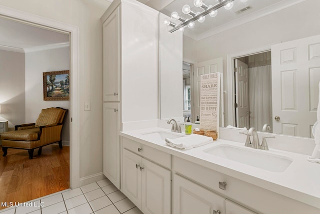 bathroom featuring vanity, crown molding, and tile patterned flooring