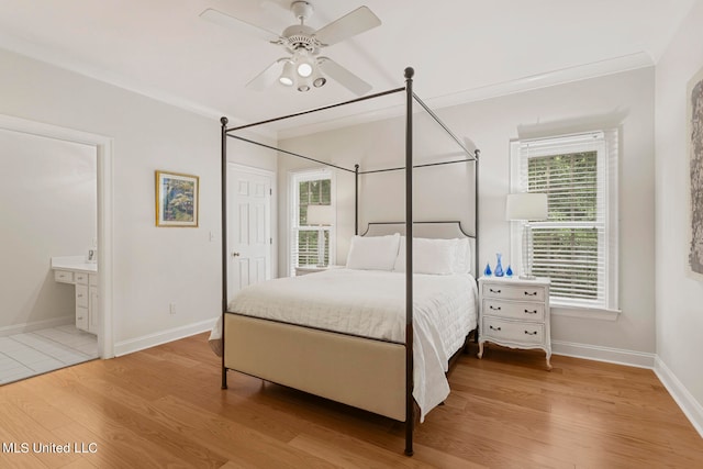 bedroom featuring ornamental molding, ensuite bathroom, light hardwood / wood-style floors, and ceiling fan