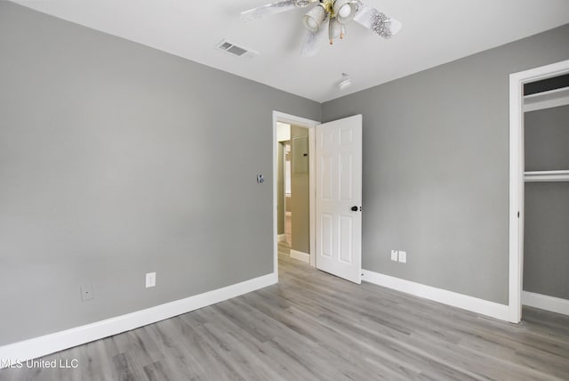 unfurnished bedroom with light wood-type flooring, visible vents, ceiling fan, and baseboards