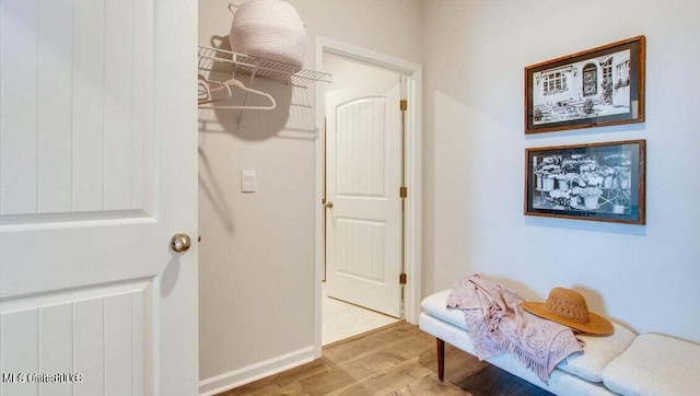 hallway with hardwood / wood-style flooring