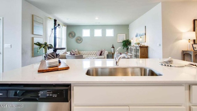 kitchen featuring sink, white cabinets, and dishwasher