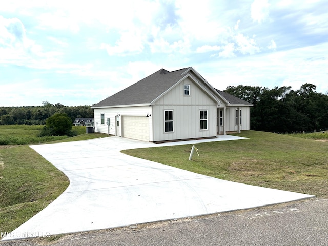 modern farmhouse featuring a front yard and a garage