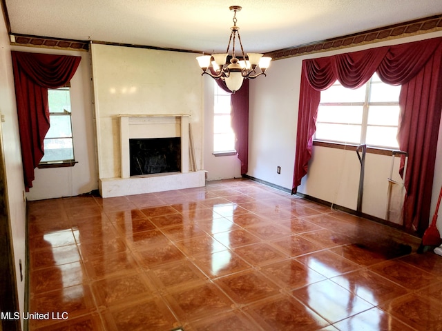 unfurnished living room with tile patterned floors, a notable chandelier, and a textured ceiling