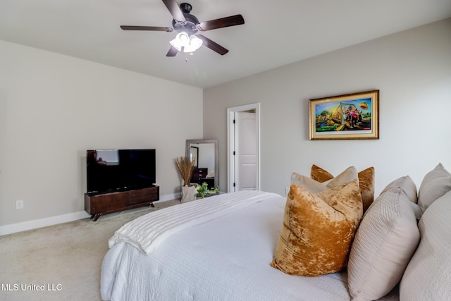 bedroom with a ceiling fan, baseboards, and light carpet