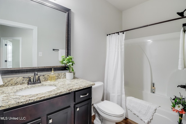full bath with vanity, shower / bath combo, and toilet