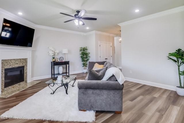 living area with recessed lighting, ornamental molding, ceiling fan, and wood finished floors