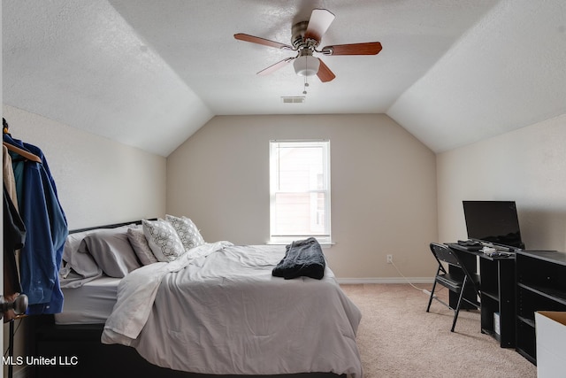 carpeted bedroom with ceiling fan, lofted ceiling, and a textured ceiling