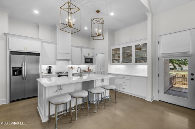 212 Ashbury Cv, Canton, MS 39046 - kitchen with decorative backsplash, white cabinets, concrete floors, built in appliances, and ornamental molding