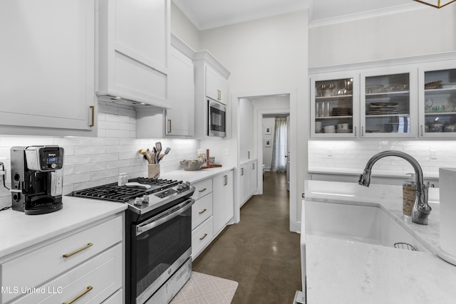 212 Ashbury Cv, Canton, MS 39046 - kitchen with decorative backsplash, concrete flooring, glass insert cabinets, a sink, and stainless steel appliances