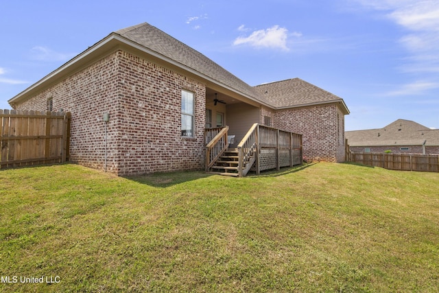 212 Ashbury Cv, Canton, MS 39046 - back of property with a fenced backyard, ceiling fan, and brick siding