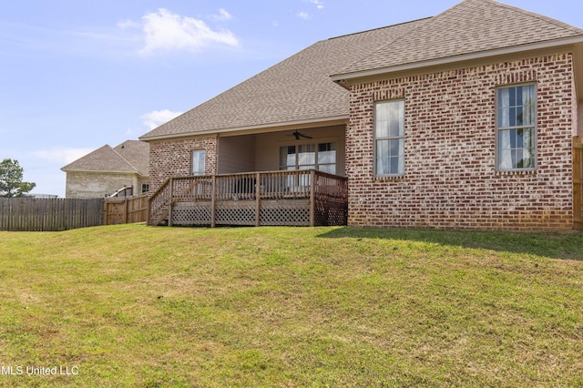 212 Ashbury Cv, Canton, MS 39046 - back of house with brick siding, ceiling fan, roof with shingles, and fence