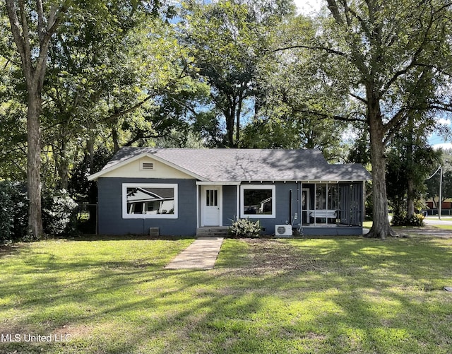18 Eubanks, Lucedale, MS 39452 - view of front of property with roof with shingles, concrete block siding, a sunroom, and a front lawn