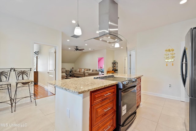 kitchen with black electric range oven, island exhaust hood, stainless steel fridge, light stone countertops, and decorative light fixtures