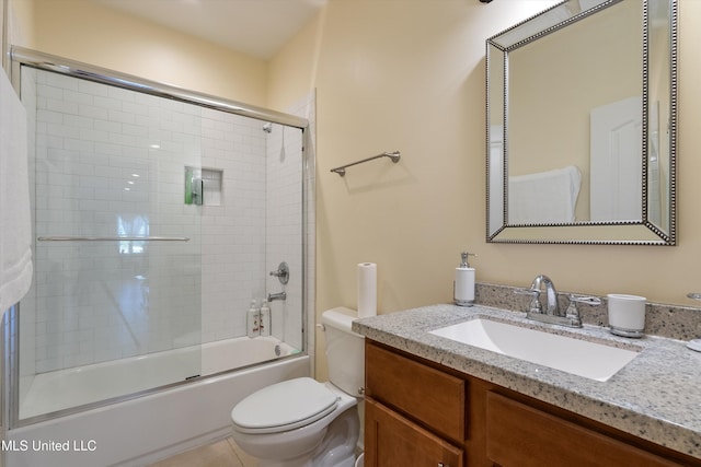 full bathroom with vanity, combined bath / shower with glass door, toilet, and tile patterned flooring