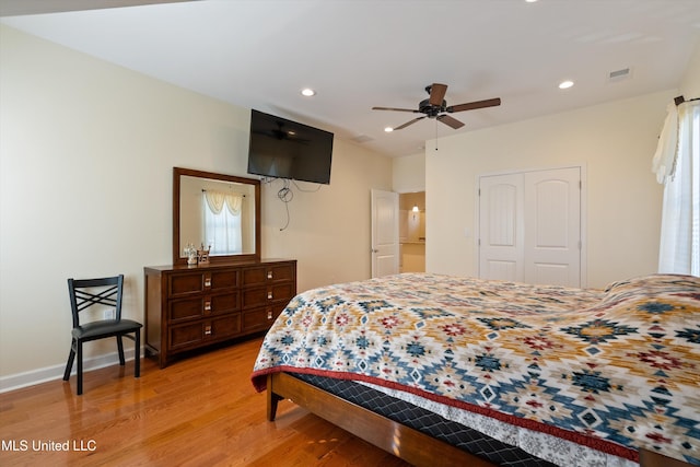 bedroom featuring a closet, ceiling fan, and light wood-type flooring