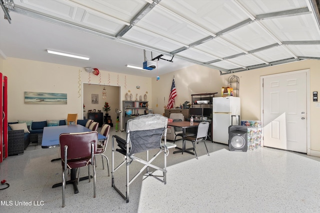 garage with a garage door opener and white refrigerator