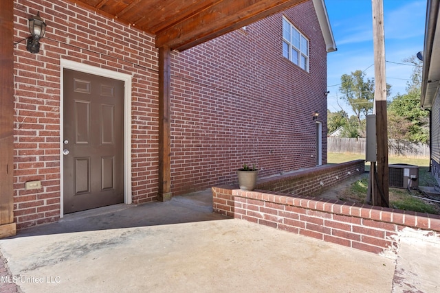 property entrance with central AC and a patio area