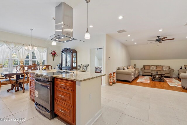 kitchen featuring island exhaust hood, an island with sink, light stone countertops, electric range, and decorative light fixtures