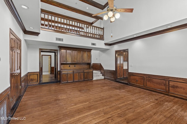 316 Meadow Creek Pl, Jackson, MS 39211 - unfurnished living room featuring a wainscoted wall, a ceiling fan, dark wood-style flooring, crown molding, and recessed lighting