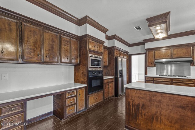 316 Meadow Creek Pl, Jackson, MS 39211 - kitchen featuring appliances with stainless steel finishes, under cabinet range hood, light countertops, ornamental molding, and dark brown cabinetry