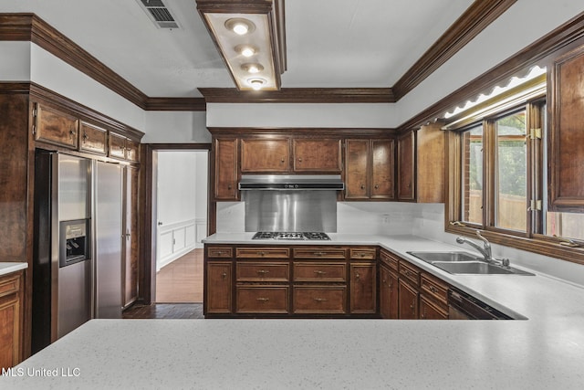 316 Meadow Creek Pl, Jackson, MS 39211 - kitchen featuring stainless steel appliances, under cabinet range hood, a sink, light countertops, and crown molding