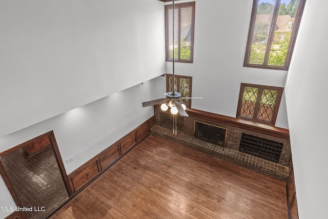 316 Meadow Creek Pl, Jackson, MS 39211 - unfurnished living room with wood finished floors, ceiling fan, and a towering ceiling