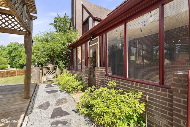 316 Meadow Creek Pl, Jackson, MS 39211 - view of home's exterior with brick siding, a deck, and a shingled roof