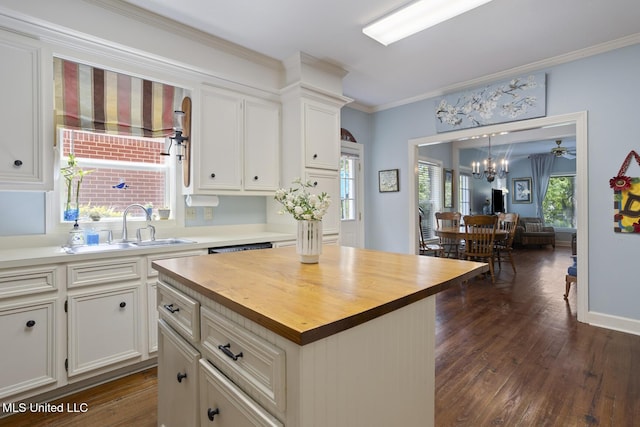 39 Moss Forest Cir, Jackson, MS 39211 - kitchen featuring wooden counters, white cabinets, a sink, dark wood-style floors, and crown molding