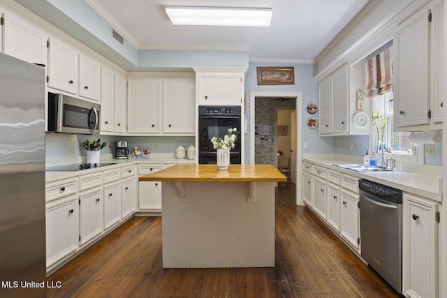 39 Moss Forest Cir, Jackson, MS 39211 - kitchen featuring dark wood finished floors, butcher block counters, black appliances, ornamental molding, and white cabinetry