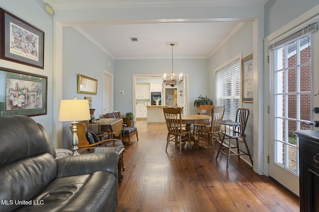 39 Moss Forest Cir, Jackson, MS 39211 - dining area with crown molding, hardwood / wood-style floors, a chandelier, and a healthy amount of sunlight