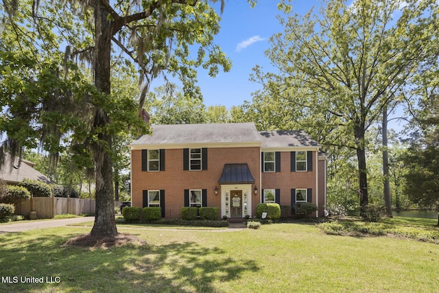 39 Moss Forest Cir, Jackson, MS 39211 - colonial-style house featuring fence, a front yard, and brick siding