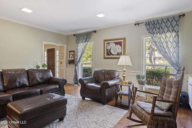 39 Moss Forest Cir, Jackson, MS 39211 - living area featuring wood finished floors, a wainscoted wall, crown molding, and a decorative wall