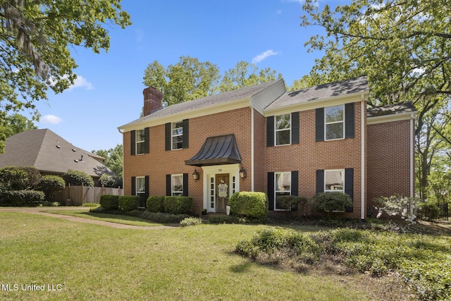 39 Moss Forest Cir, Jackson, MS 39211 - colonial house featuring fence, a chimney, brick siding, and a front lawn