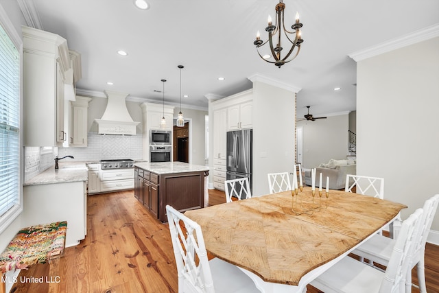 413 Miles Cv, Brandon, MS 39047 - dining area with crown molding, light wood-style flooring, recessed lighting, a ceiling fan, and a chandelier
