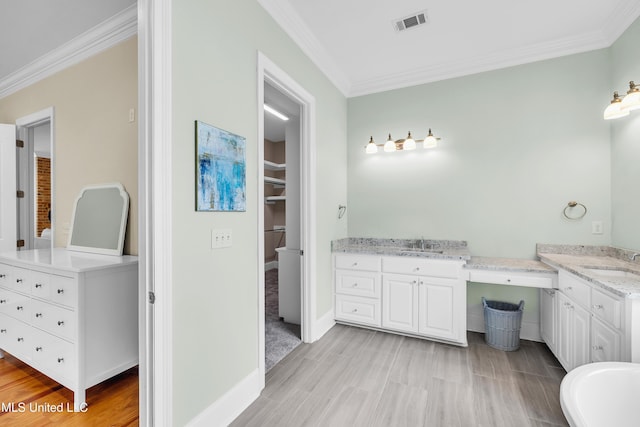 413 Miles Cv, Brandon, MS 39047 - bathroom with crown molding, vanity, wood finished floors, and baseboards