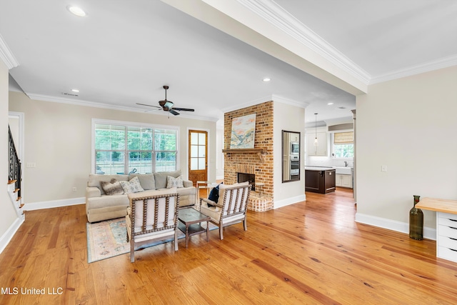 413 Miles Cv, Brandon, MS 39047 - living area with crown molding, light wood-style floors, ceiling fan, healthy amount of natural light, and baseboards