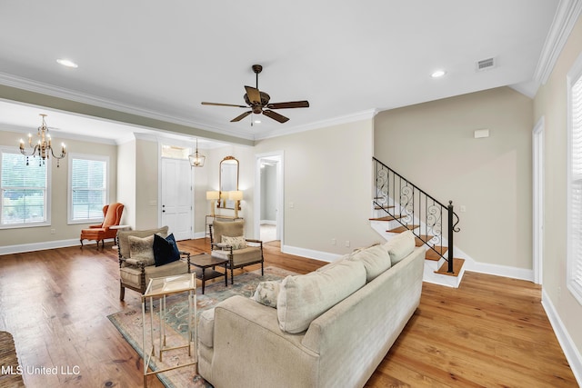 413 Miles Cv, Brandon, MS 39047 - living area featuring stairs, a chandelier, light wood-style flooring, baseboards, and ornamental molding