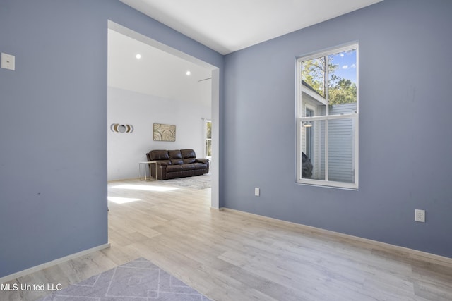 unfurnished room featuring baseboards and wood finished floors