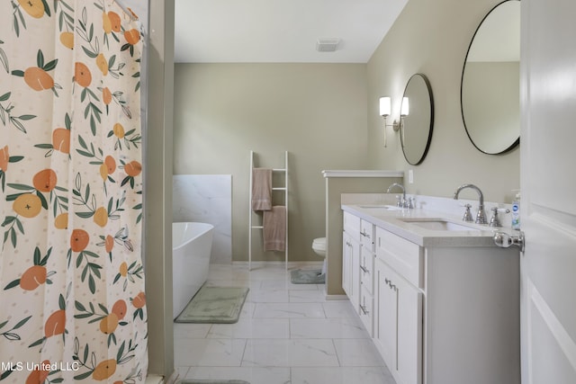 bathroom featuring a sink, a soaking tub, toilet, and marble finish floor