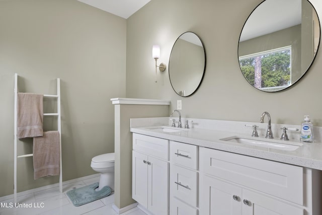 bathroom with a sink, baseboards, toilet, and double vanity