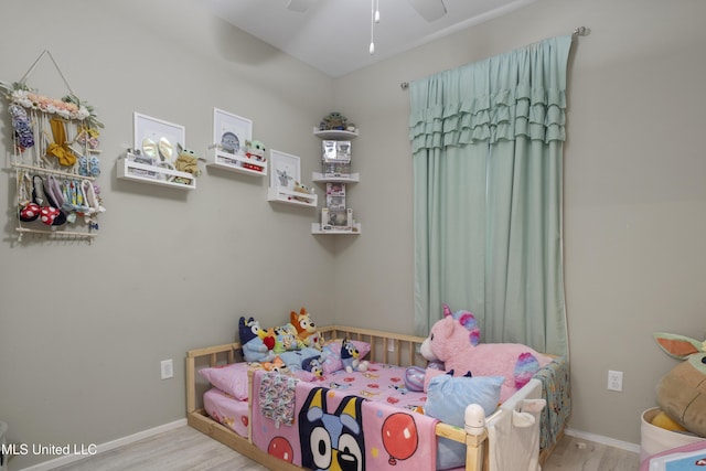 bedroom with baseboards, ceiling fan, and wood finished floors