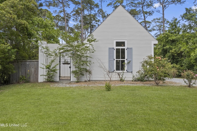 exterior space featuring a lawn and fence