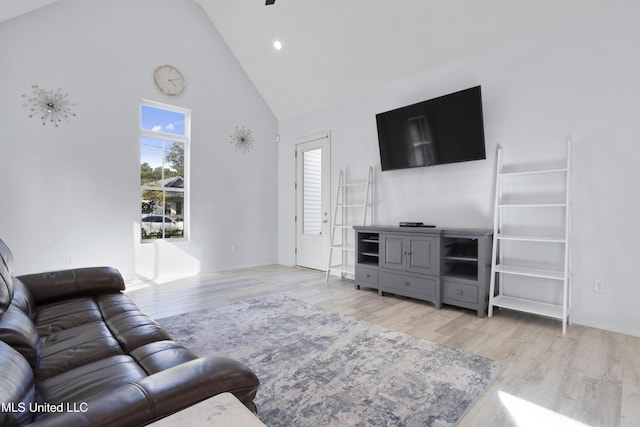 living area with light wood-style floors, high vaulted ceiling, and recessed lighting