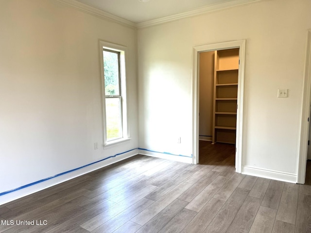 6 Hedges Plantation Pl, Natchez, MS 39120 - unfurnished bedroom featuring a spacious closet, crown molding, wood finished floors, baseboards, and a closet