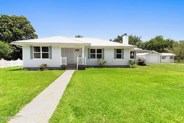 view of front of property with a garage, a front lawn, and a porch